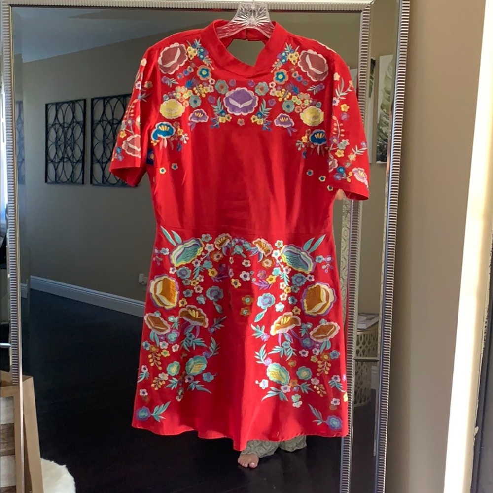 Embroider red dress with colorful flowers.